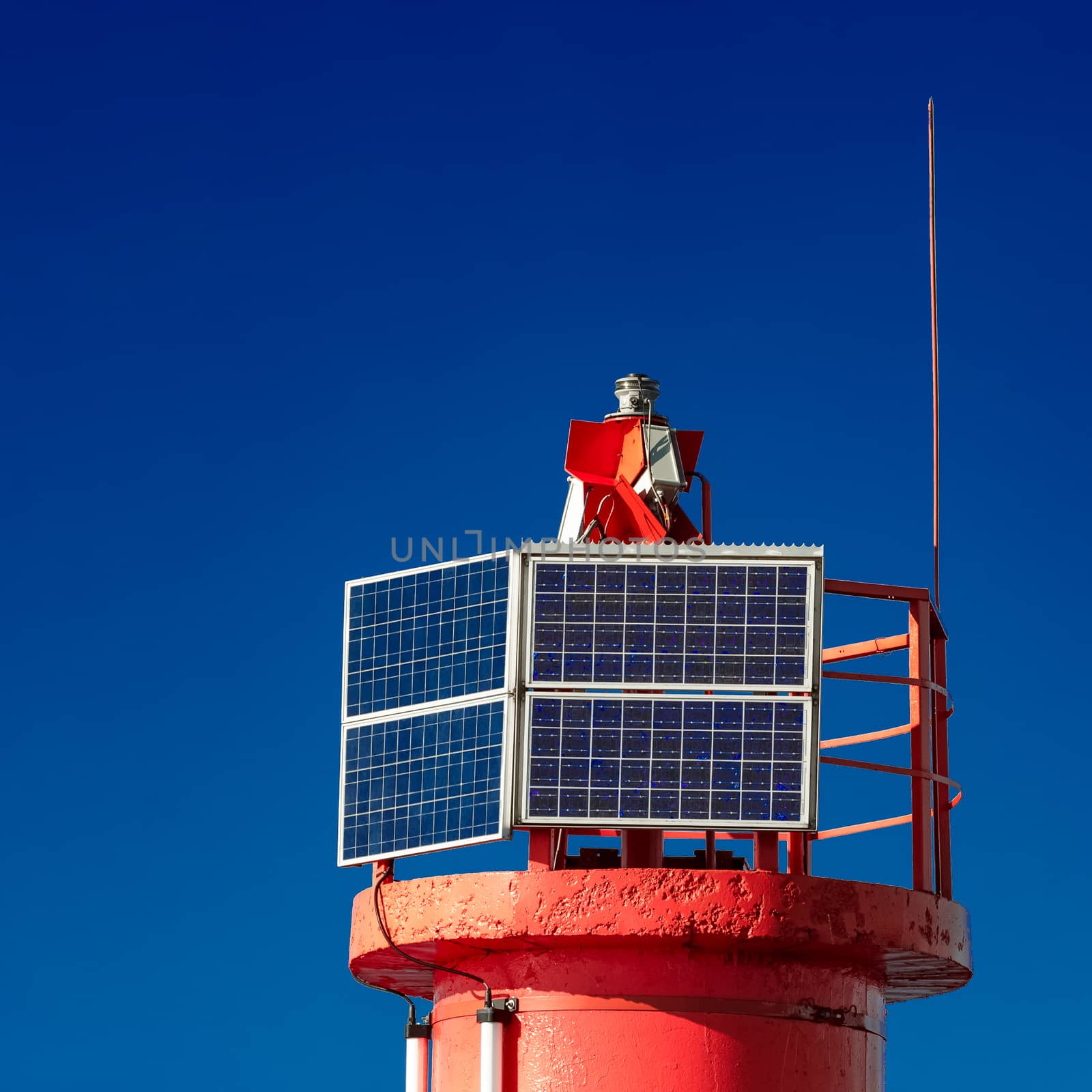 Red lighthouse against blue sky in Riga, Europe