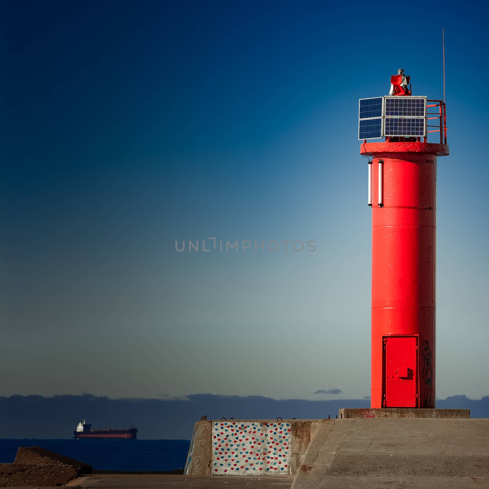 Red lighthouse on breakwater dam by sengnsp