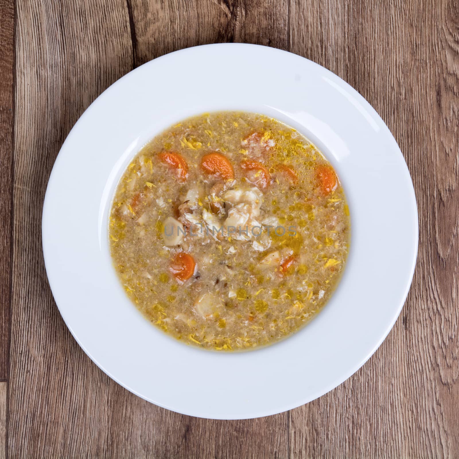 Vegetarian vegetable soup on a wooden table