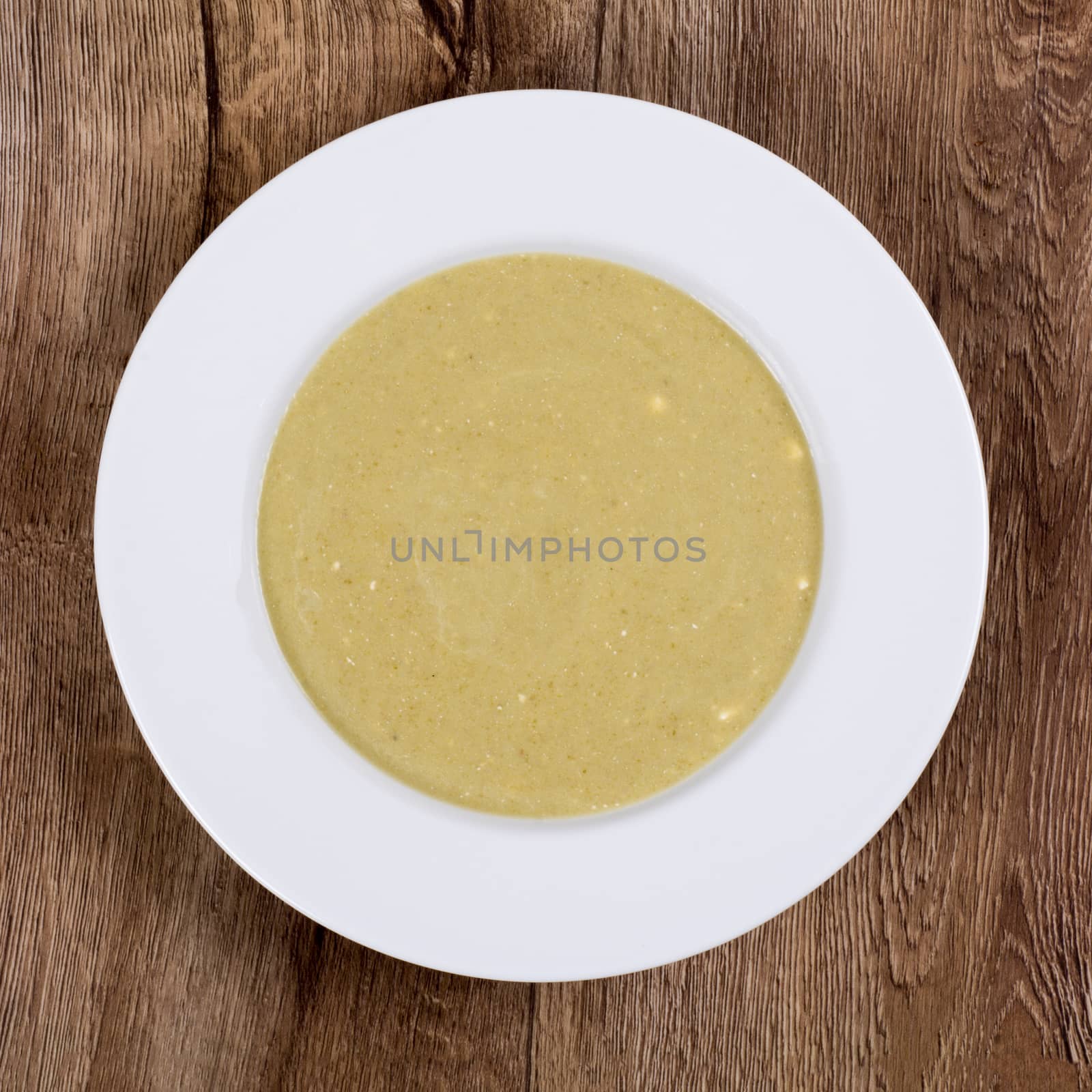 Vegetarian vegetable soup on a wooden table