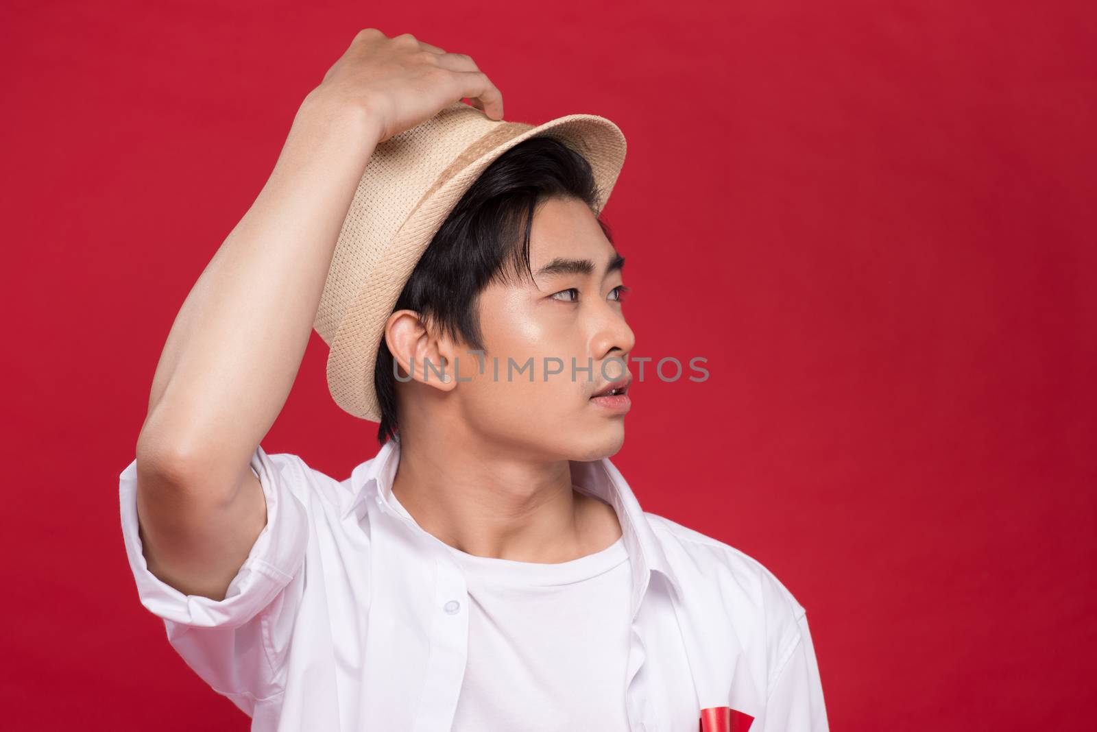 Portrait of elegant young handsome asian man with hat. Cool fash by makidotvn