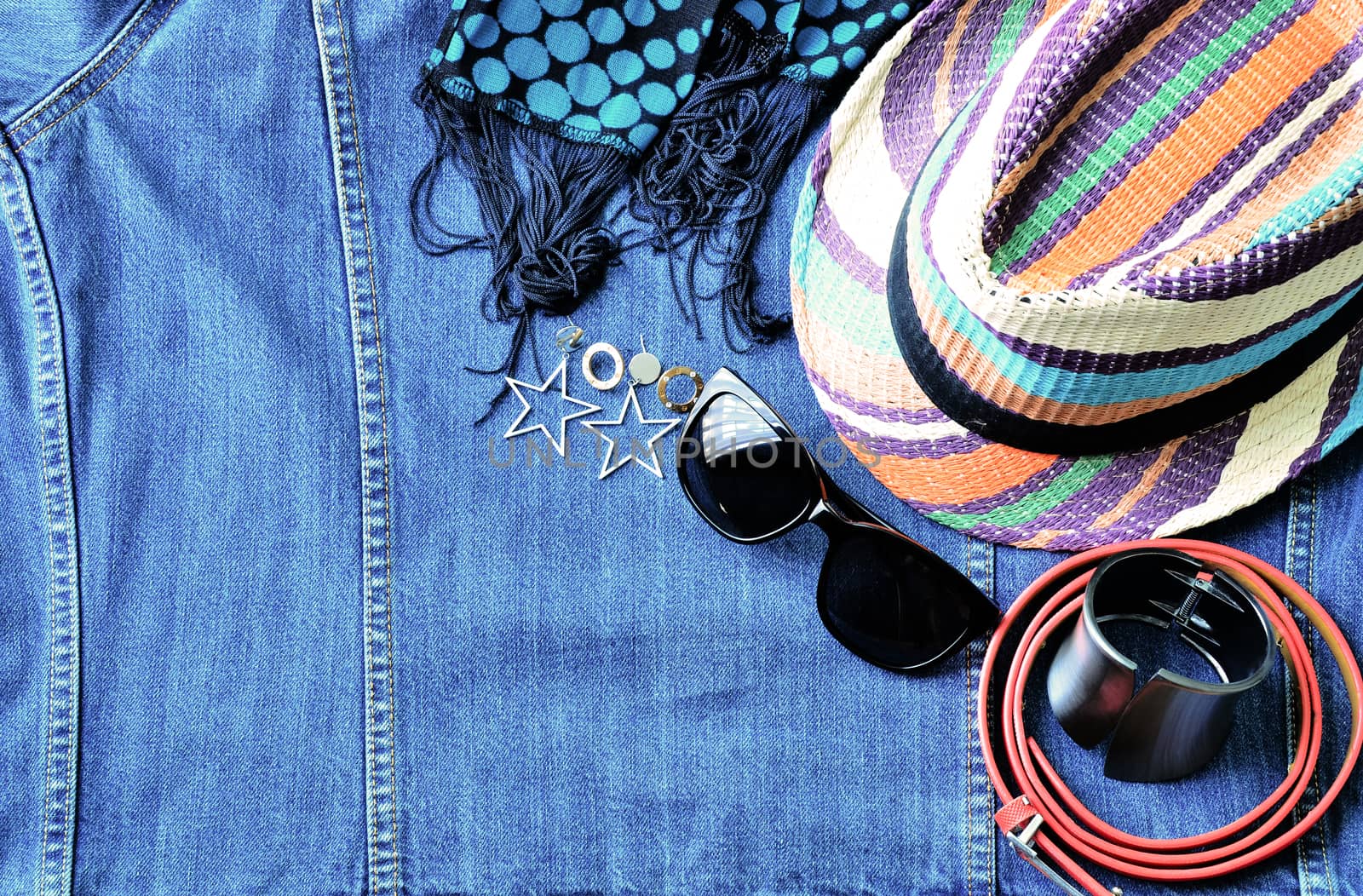 Top view of summer accessories for modern woman on denim jean ba by phochi