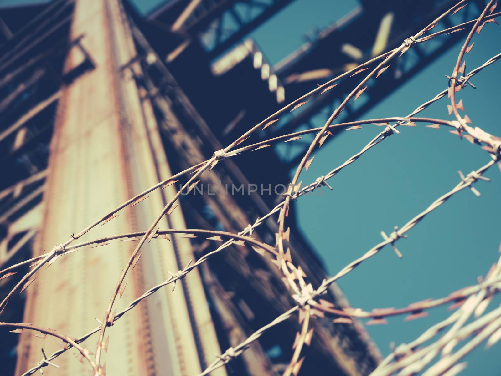 Industrial Concept Image Of Barbed Wire Around A Shipbuilding Crane