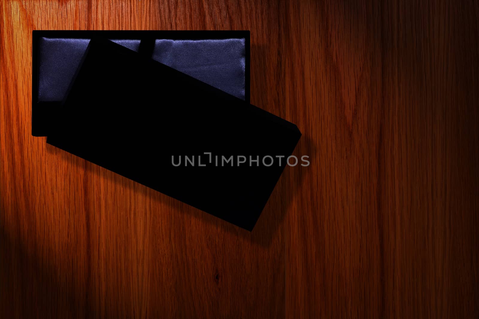 black box packaging luxury with lighting on wood background copy space