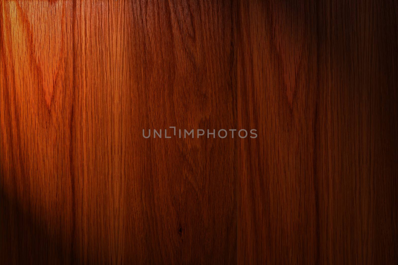 Dark brown wood background with light on the left