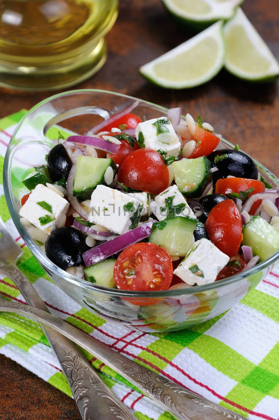 greek salad orzo pasta with black olive, red onion and cucumber, cherry tomatoes, feta and herbs