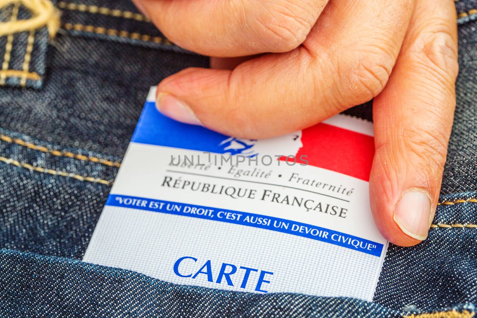 French electoral card out of the pocket of a jeans, 2017 presidential and legislative elections concept by pixinoo