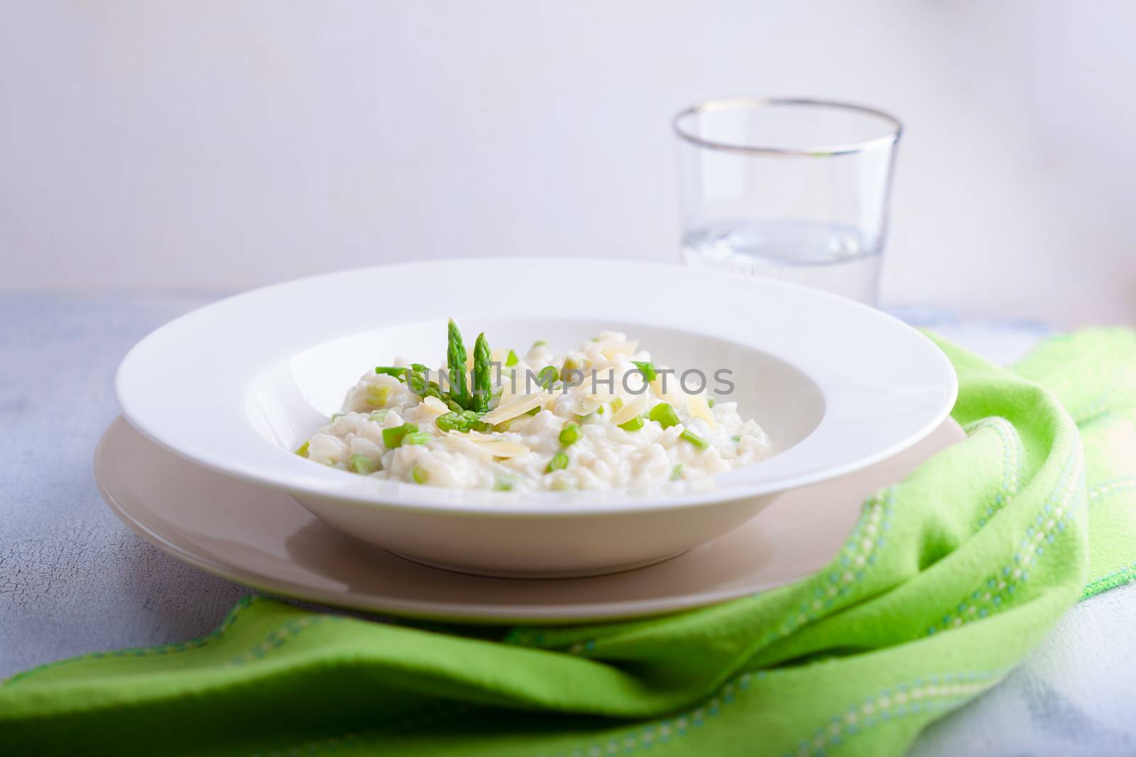 Risotto with Asparagus and cheese served on a table