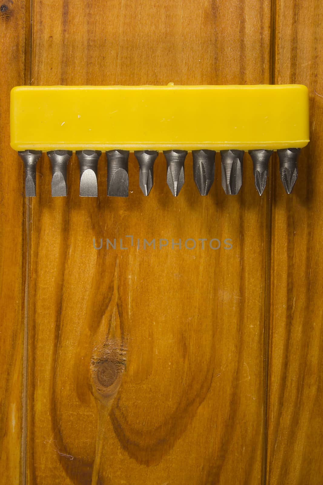 Set of screwdriver bits on a wooden background