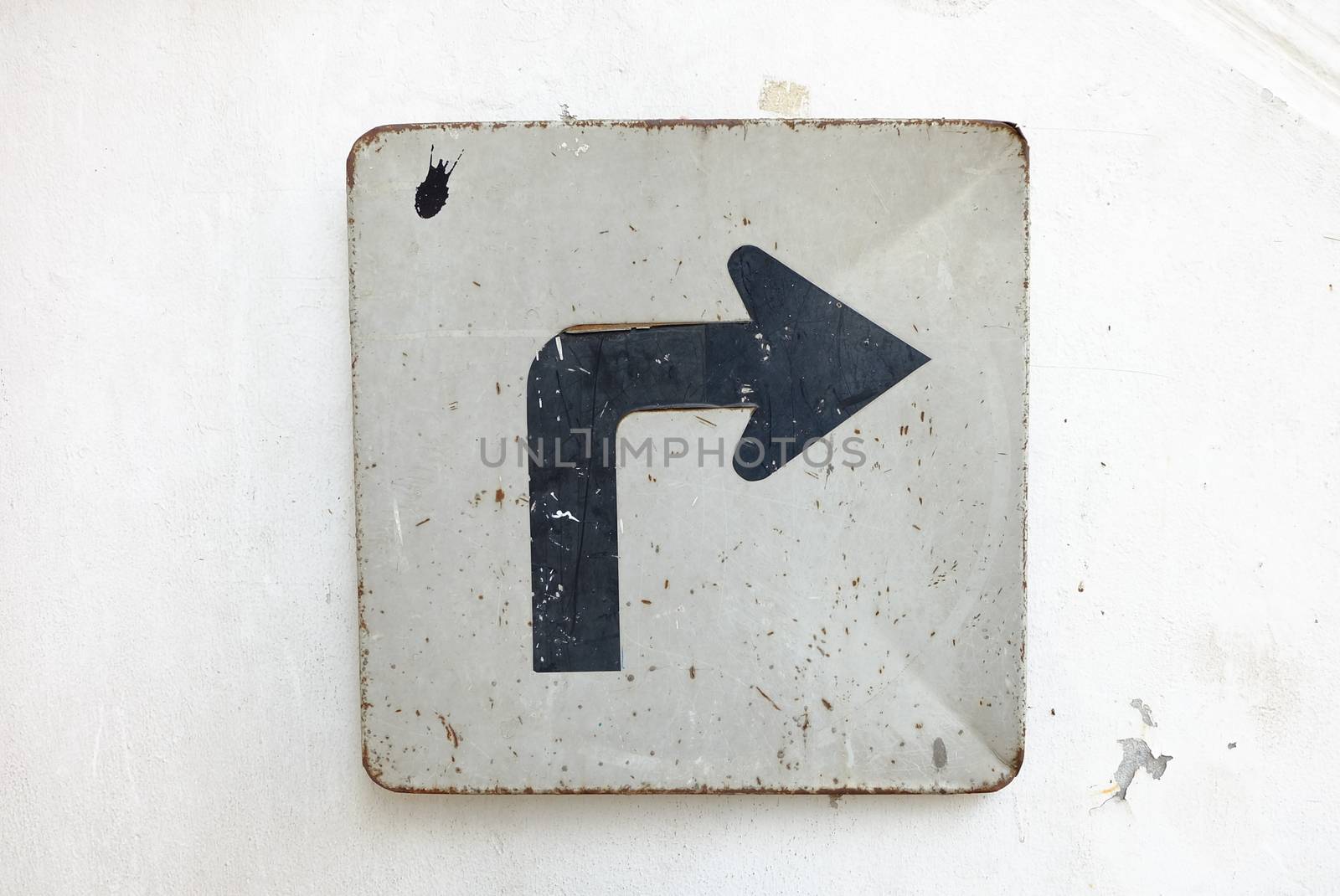 Right Arrow Sign on White Cement Wall Background.