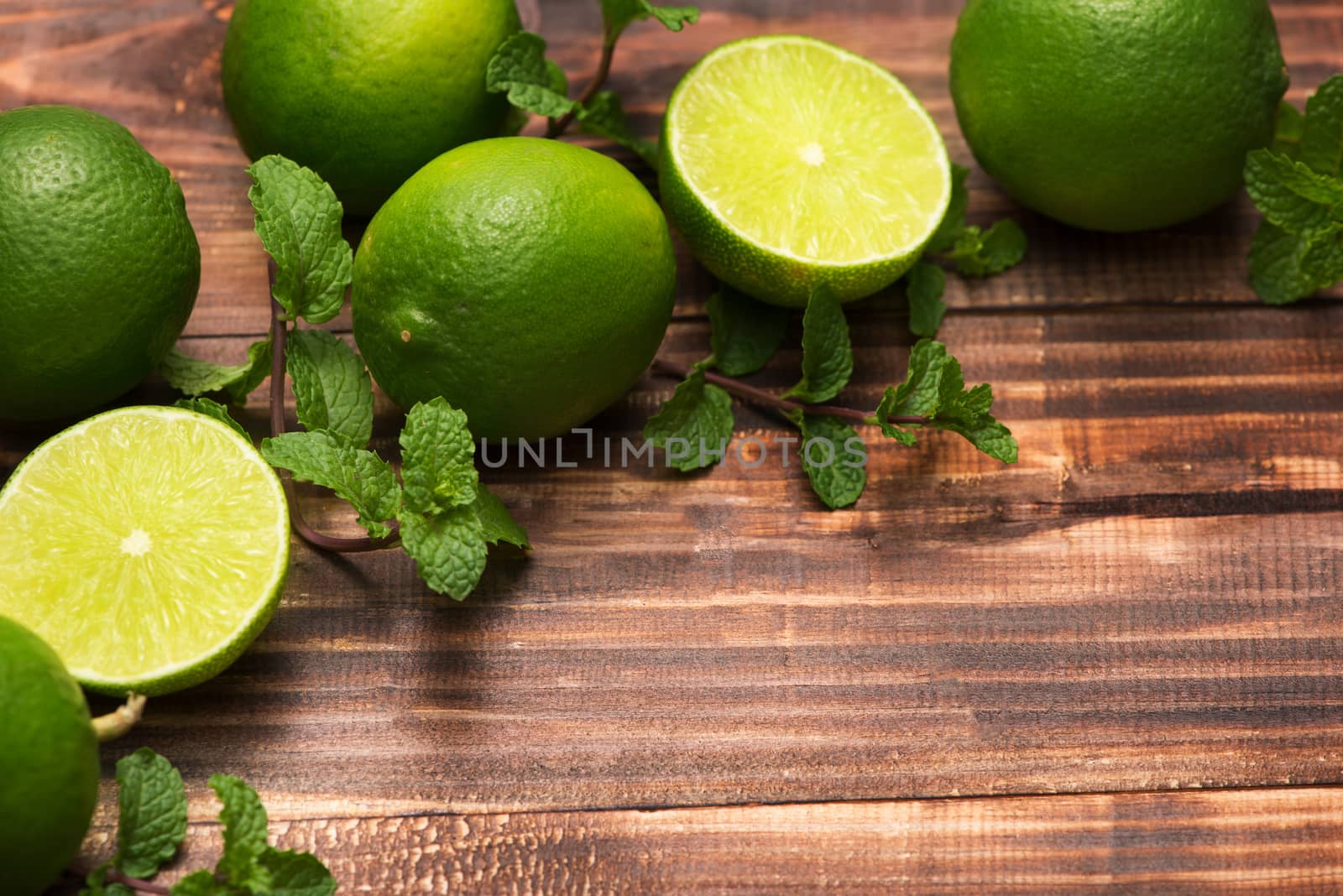 Fresh limes on wooden  table, Top view, background.