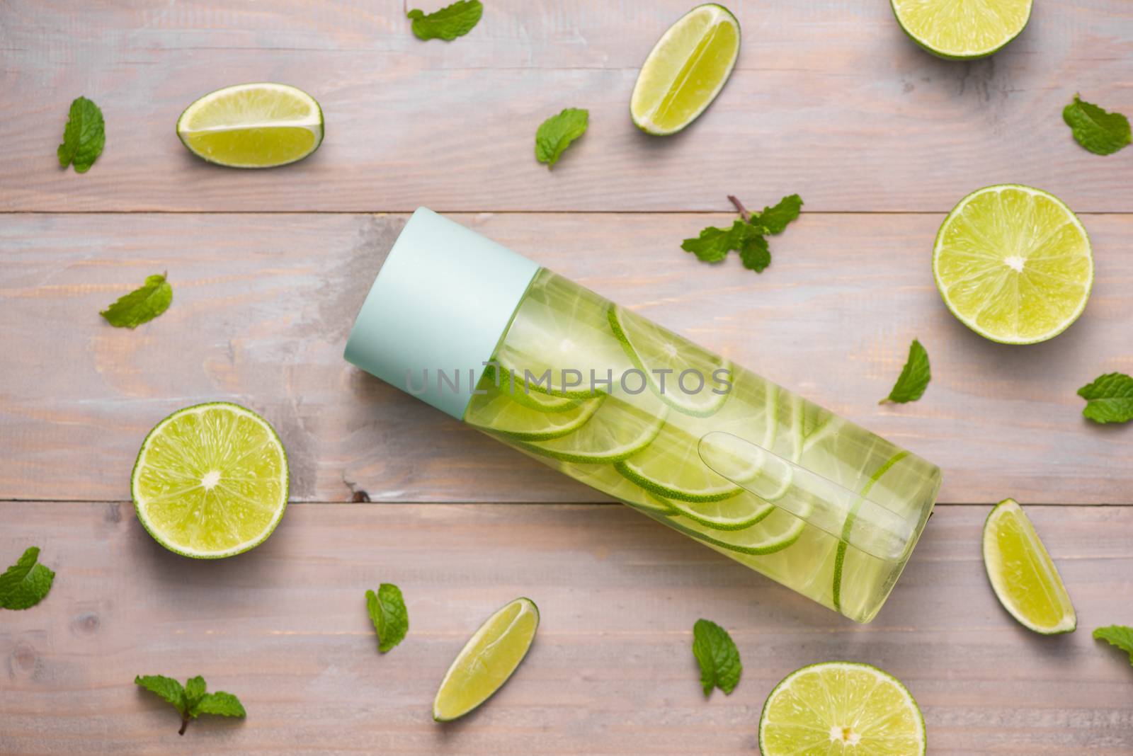 Detox Infused Water with Lime and Mint in Sports Bottle, with slices of lime.
