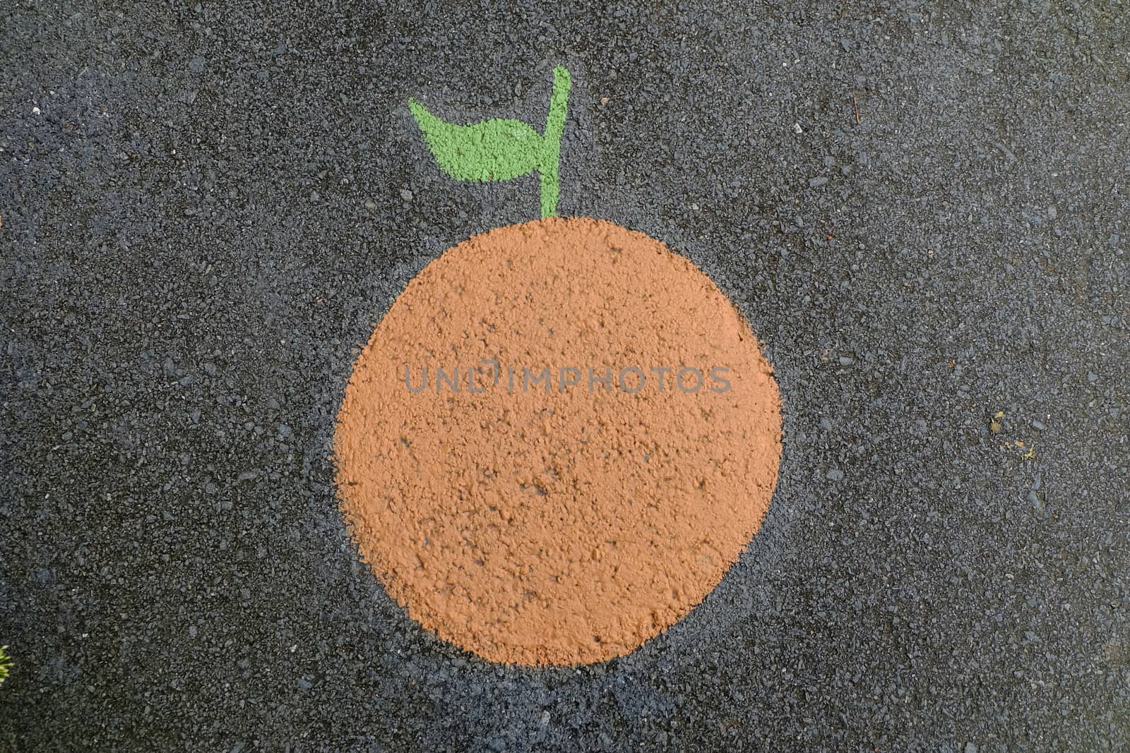 Orange Painting on Asphalt Ground.