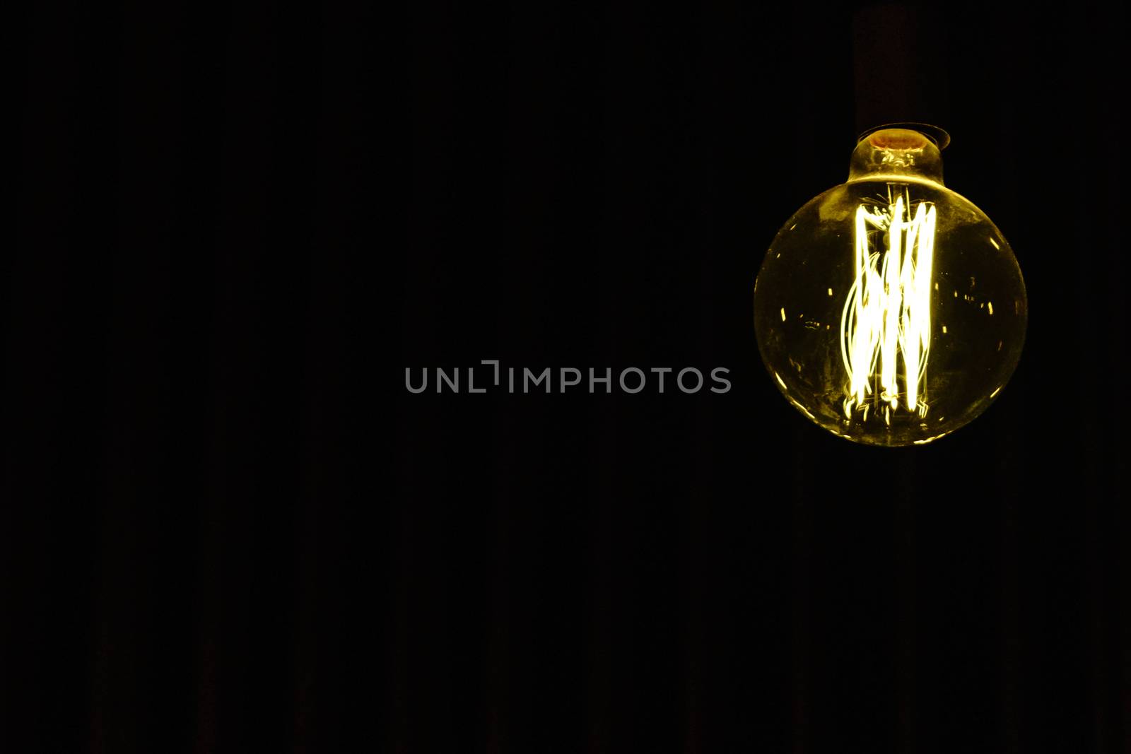 Light bulb hanging on the ceiling with whitespace by psodaz