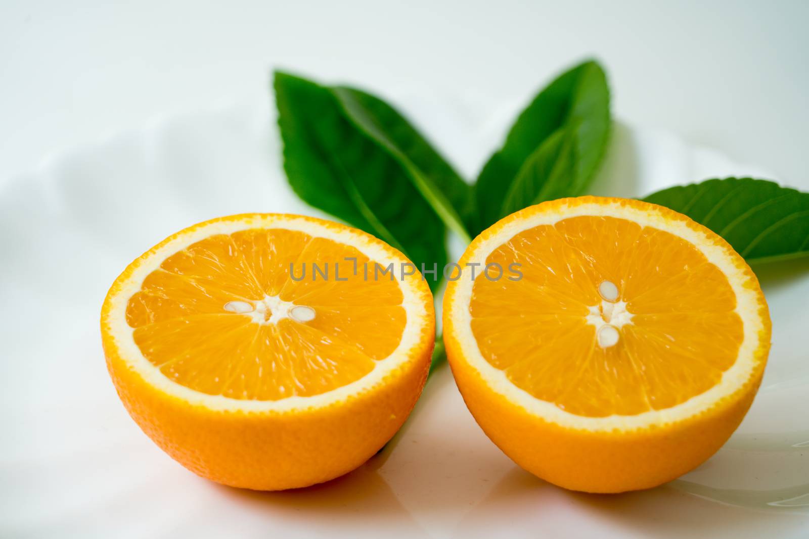 The organic slice orange on white plate - isolated