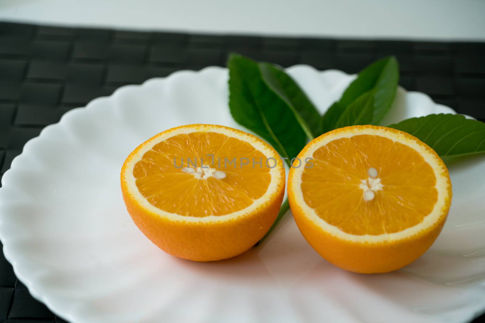 The organic slice orange on white plate - isolated by psodaz