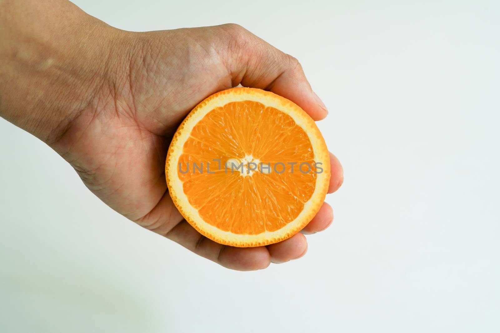 Slice organic orange holding on the hand by psodaz