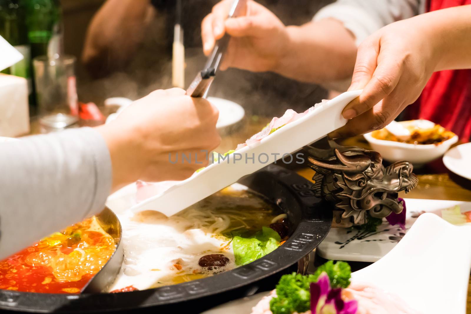 Two women are cooking the Chinese shabu hotpot by psodaz