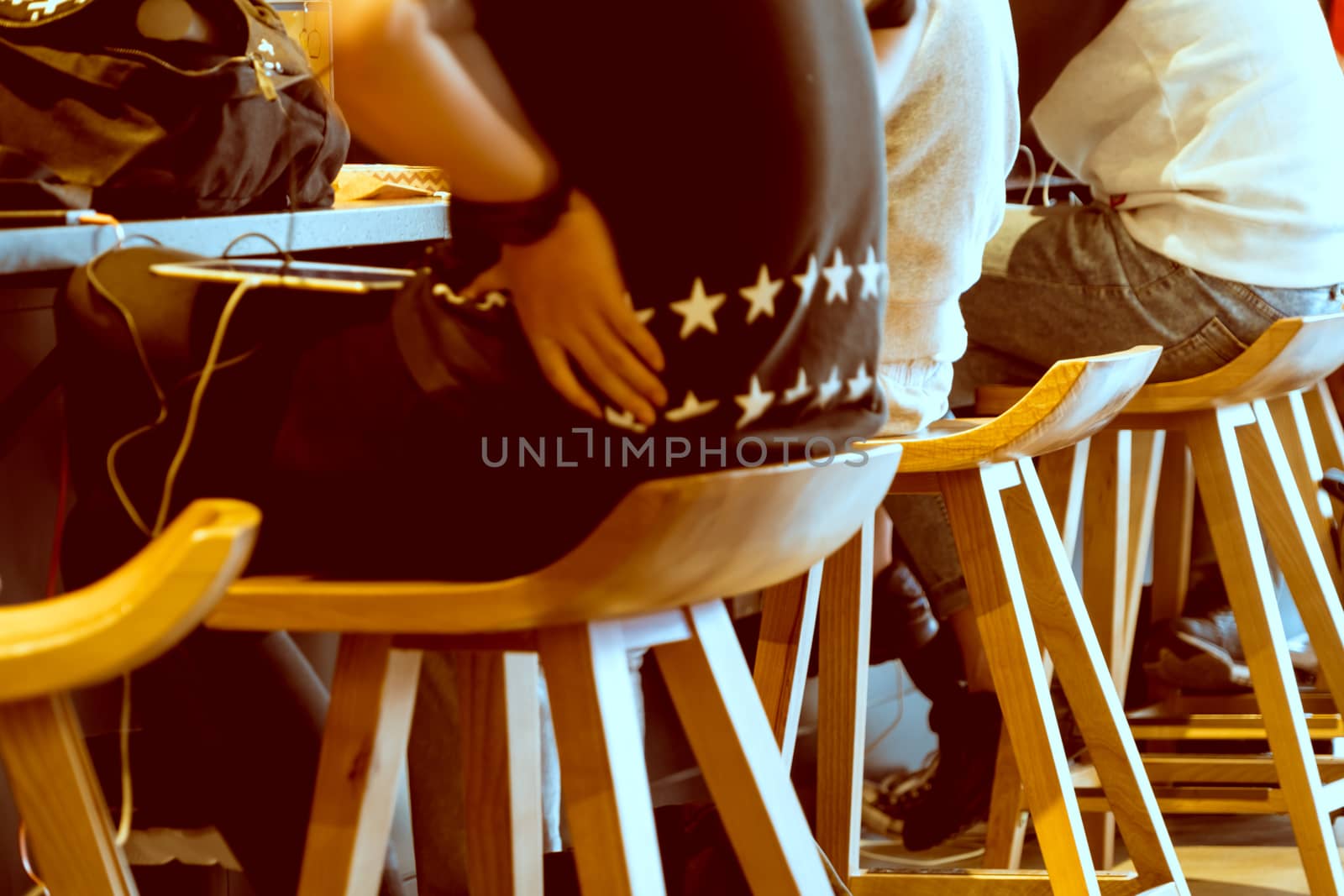 Boy group sitting on the wooden chair in coffee shop by psodaz
