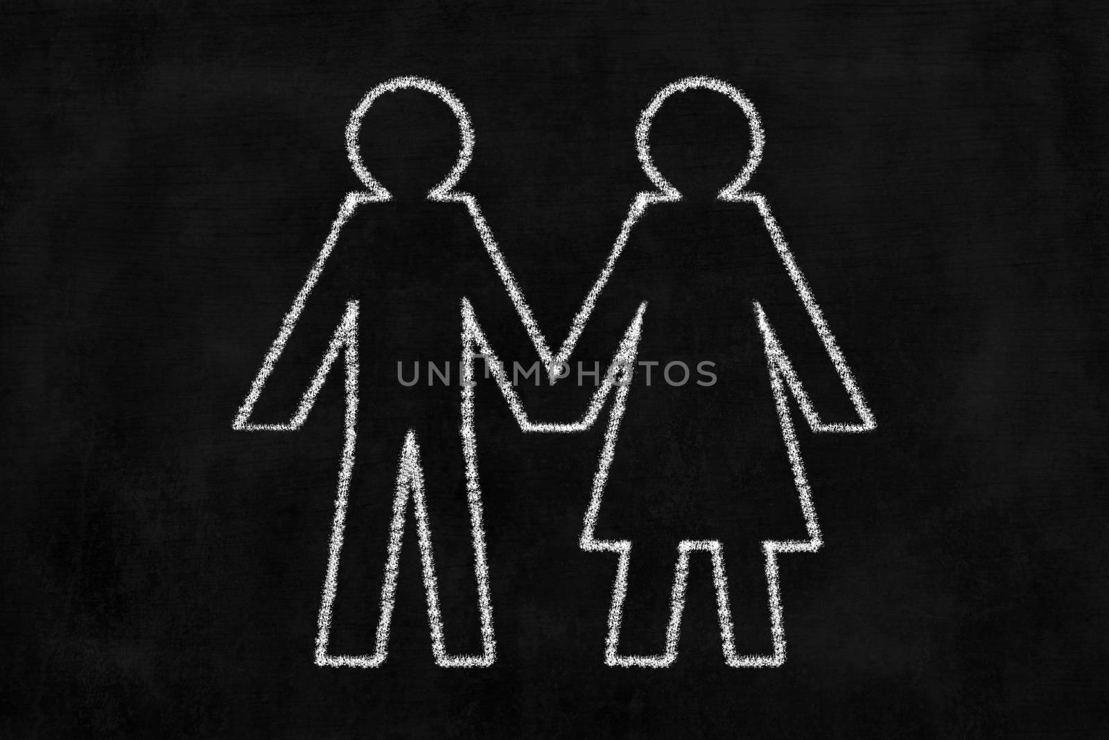Chalkboard with Man and Woman Drawing Hoding Hand.