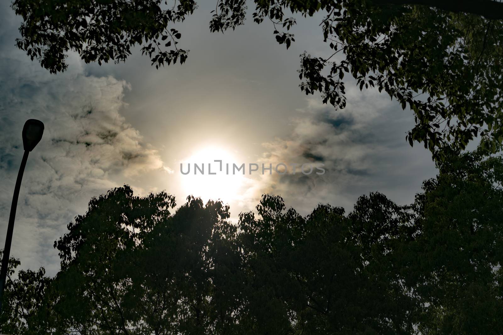 dramatic sun rays through dark sky, with filter by psodaz
