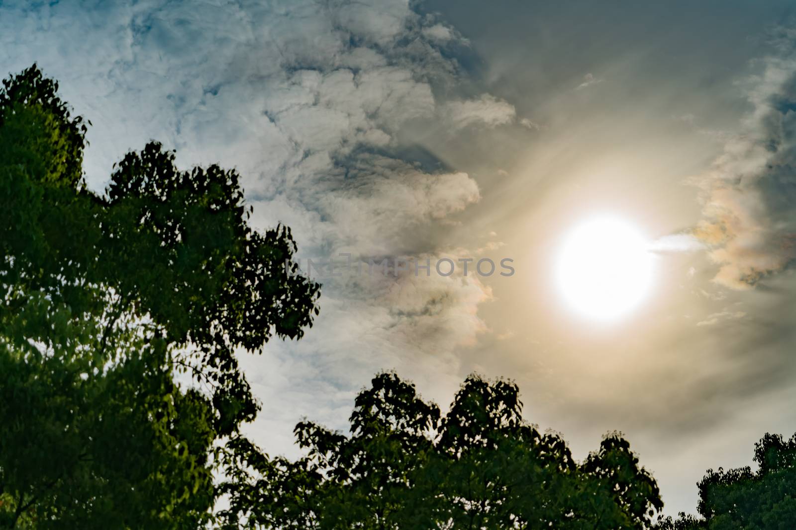 dramatic sun rays through dark sky, with filter