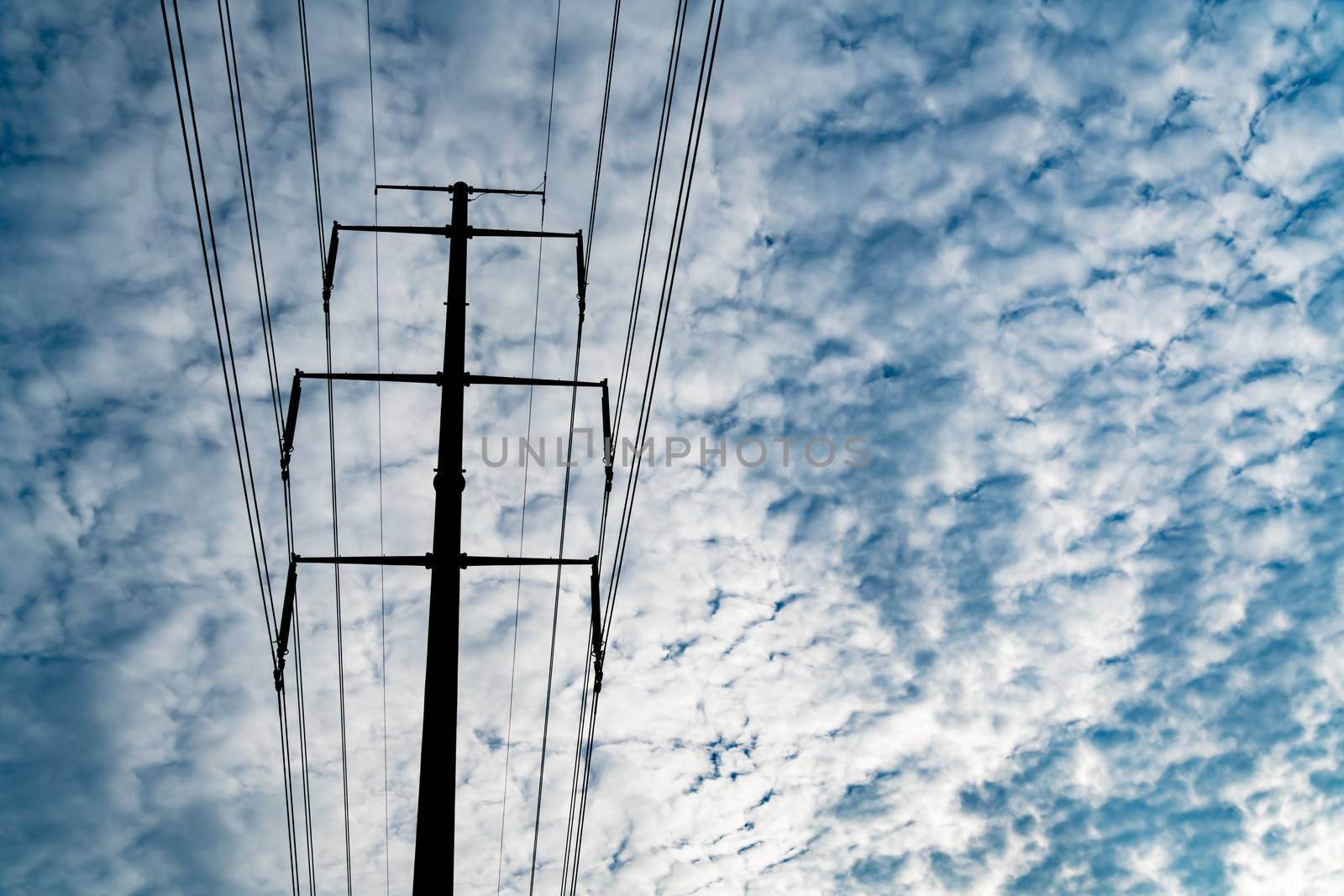 high voltage electric power supply pole on the cloudy sky background