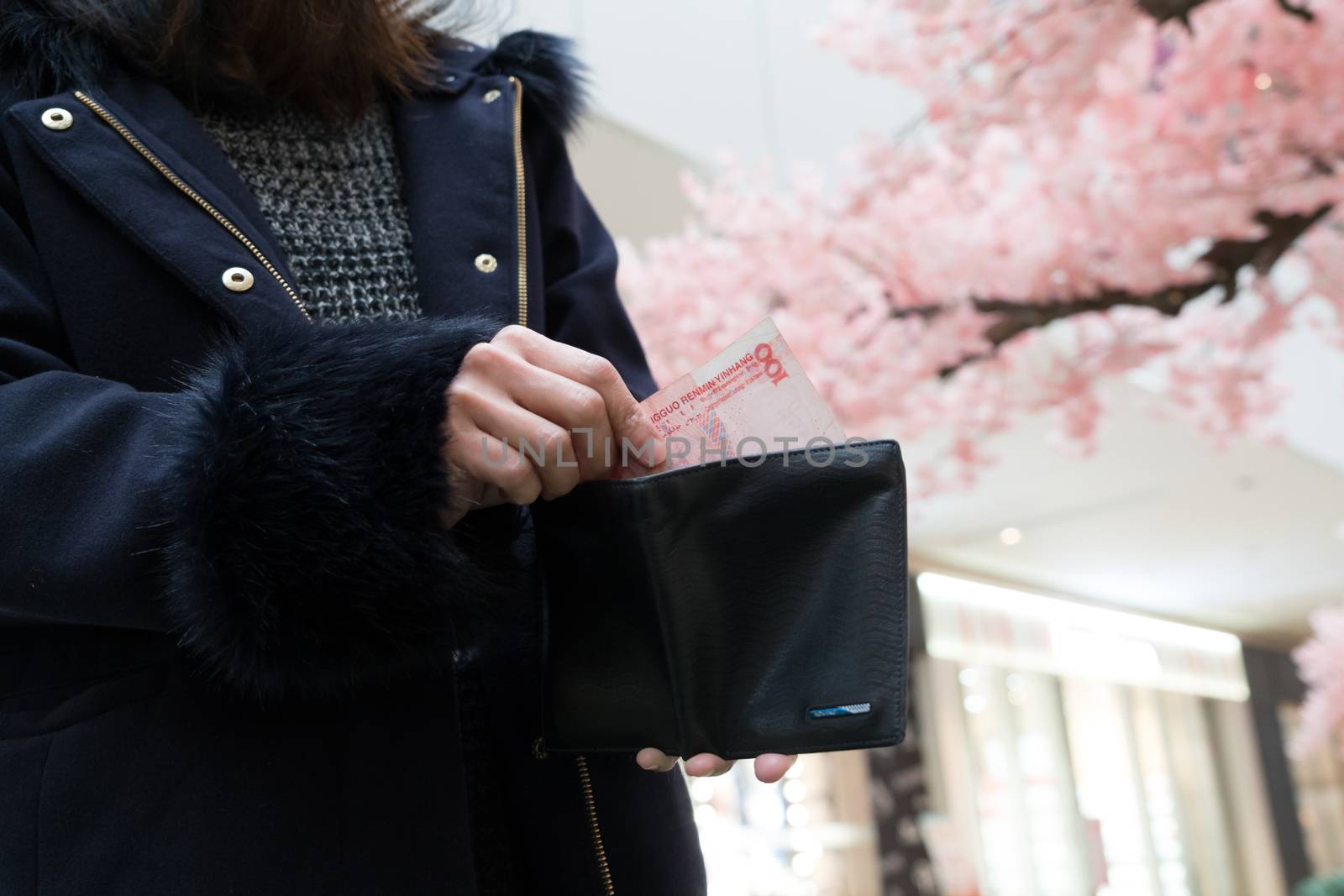 Hand holding last banknote in wallet. The woman show her last banknote from her purse on hand. poor girl.