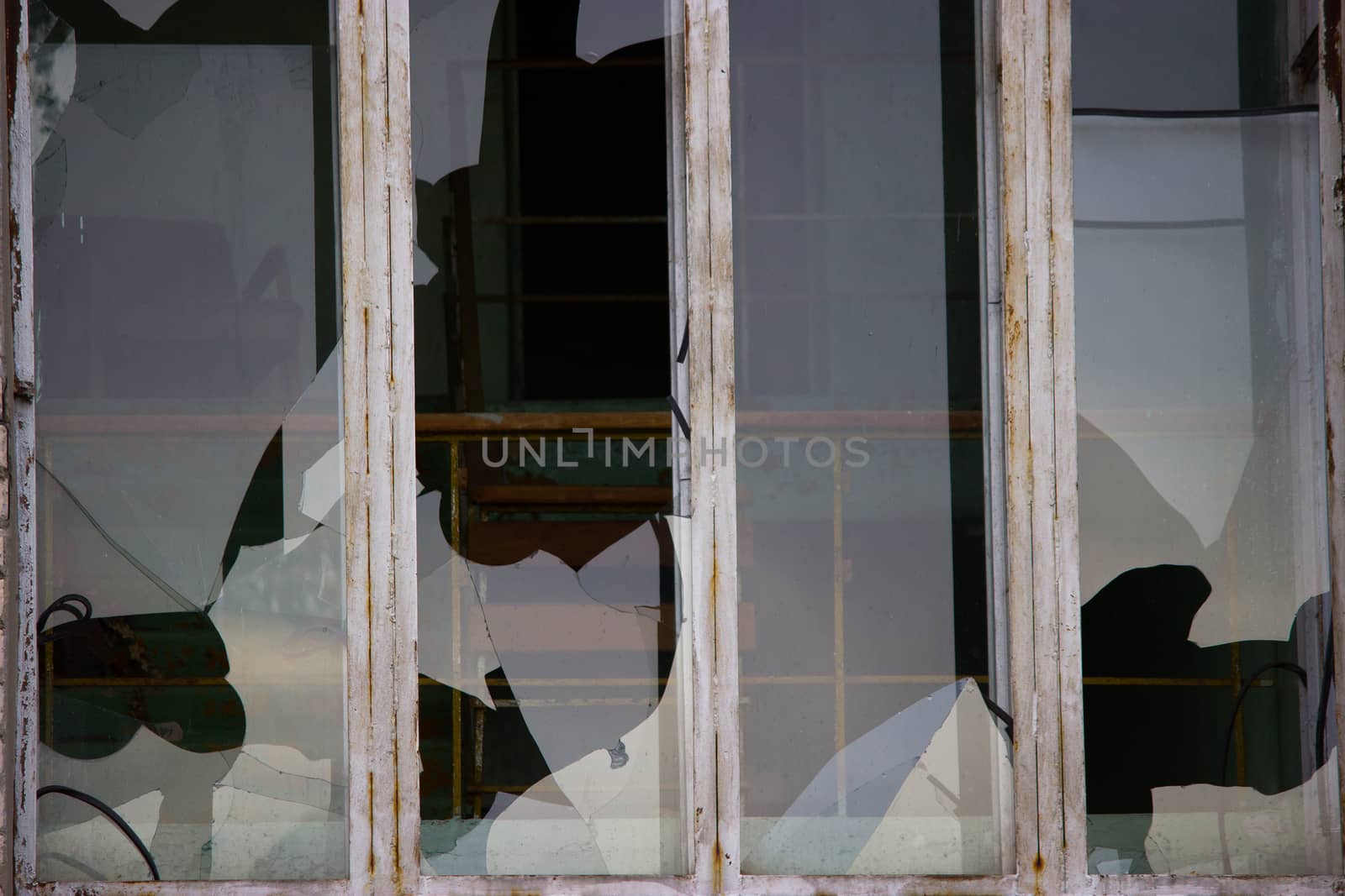 Broken windows in an old abandoned brick building