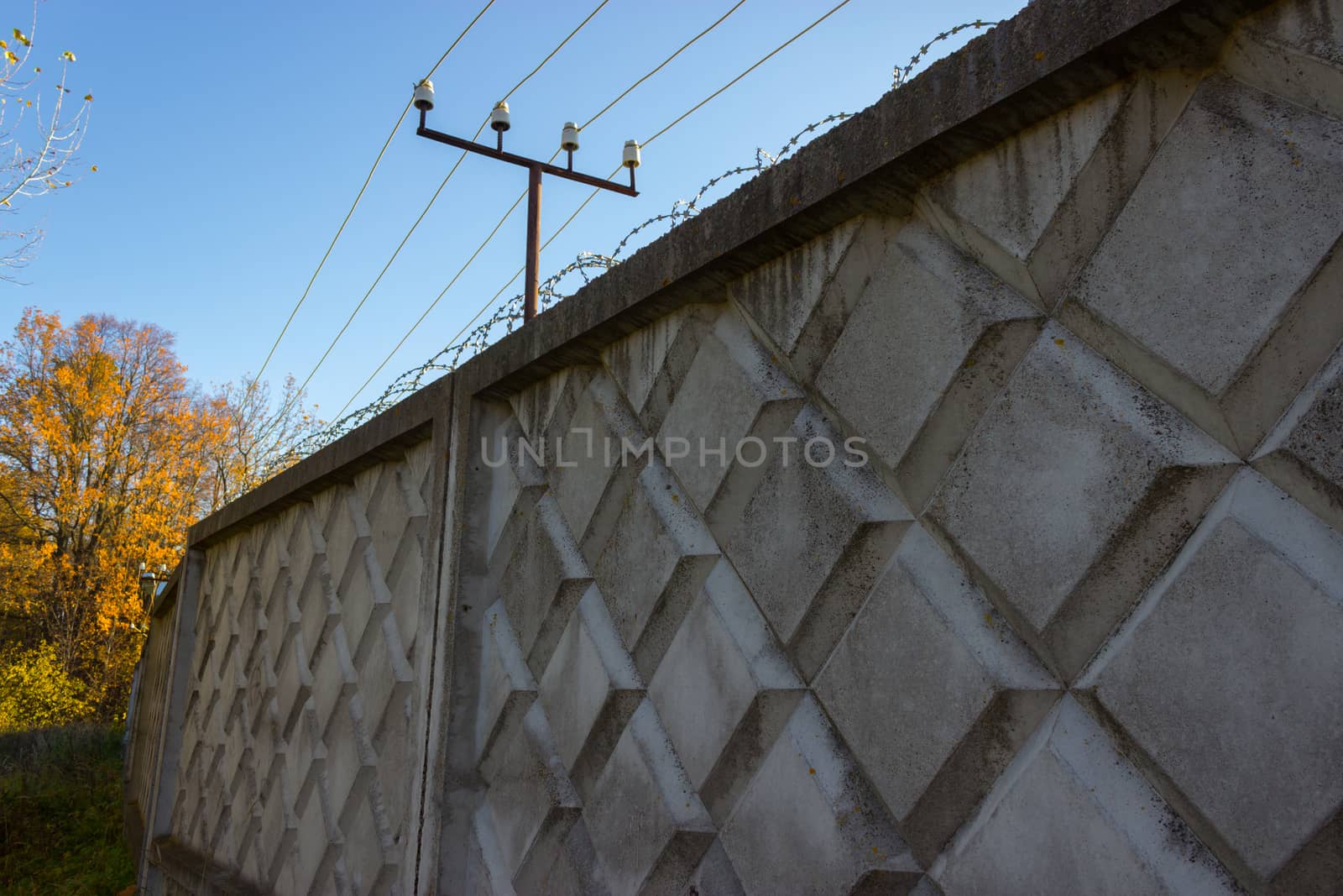 fenc ewith an electricity wire and a barbed wire