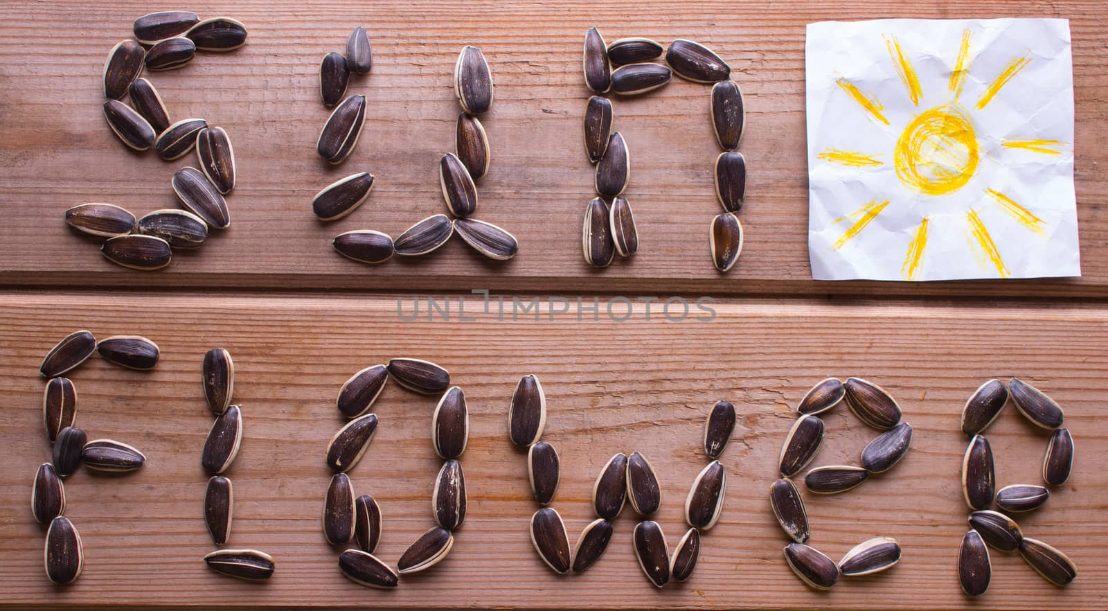 sunflower word from sunflower seeds on table. concept