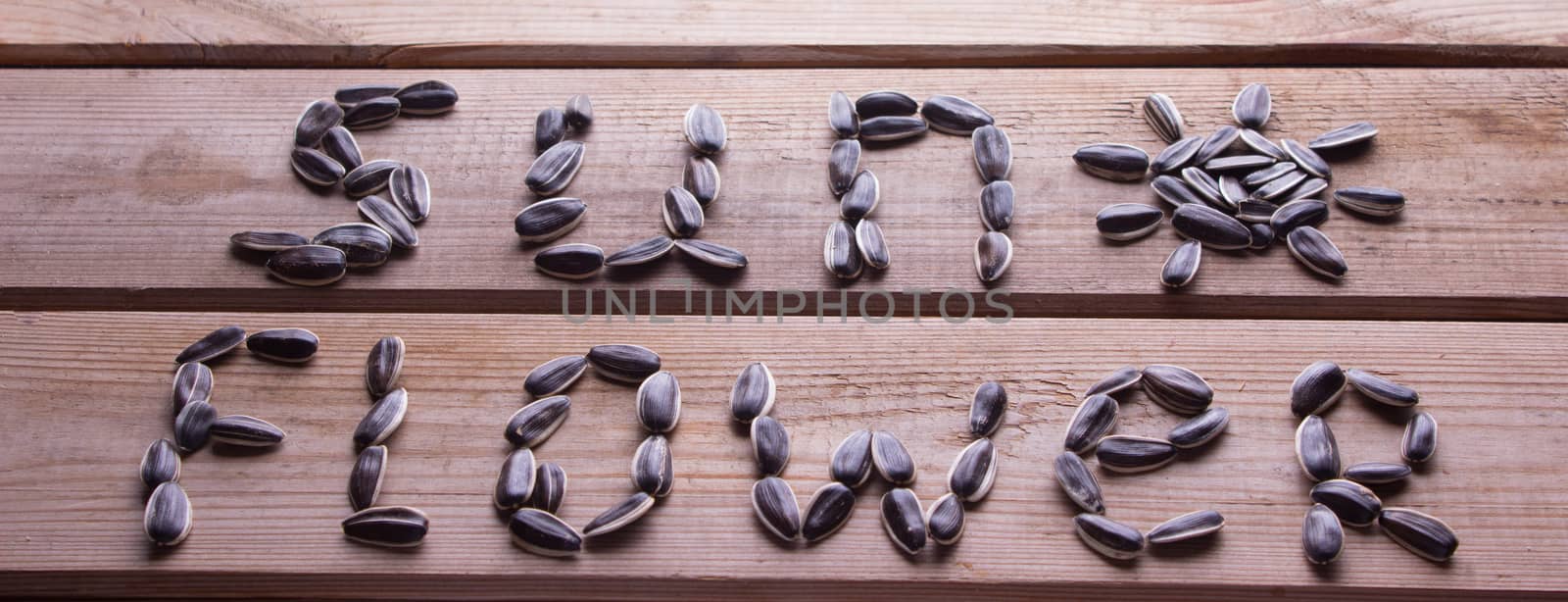 sunflower word from sunflower seeds on table. concept