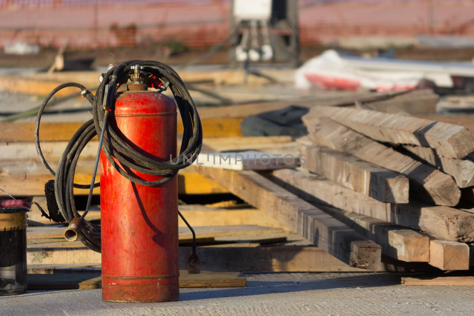 red fire extinguisher in a constraction background