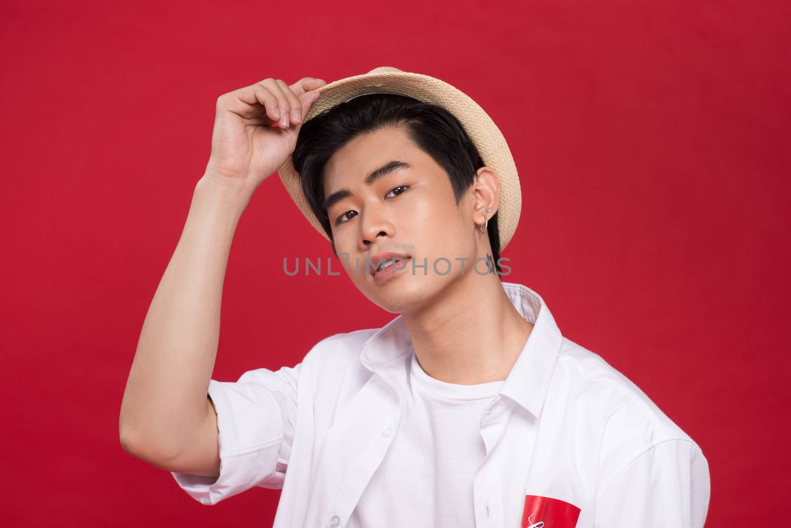 Portrait of elegant young handsome asian man with hat. Cool fashion male model.