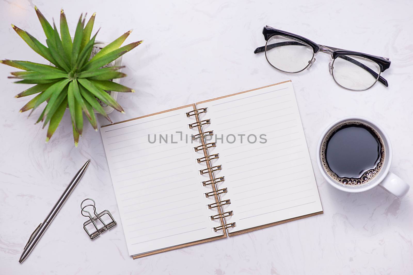 Flat lay, top view of open notebook and other supplies.