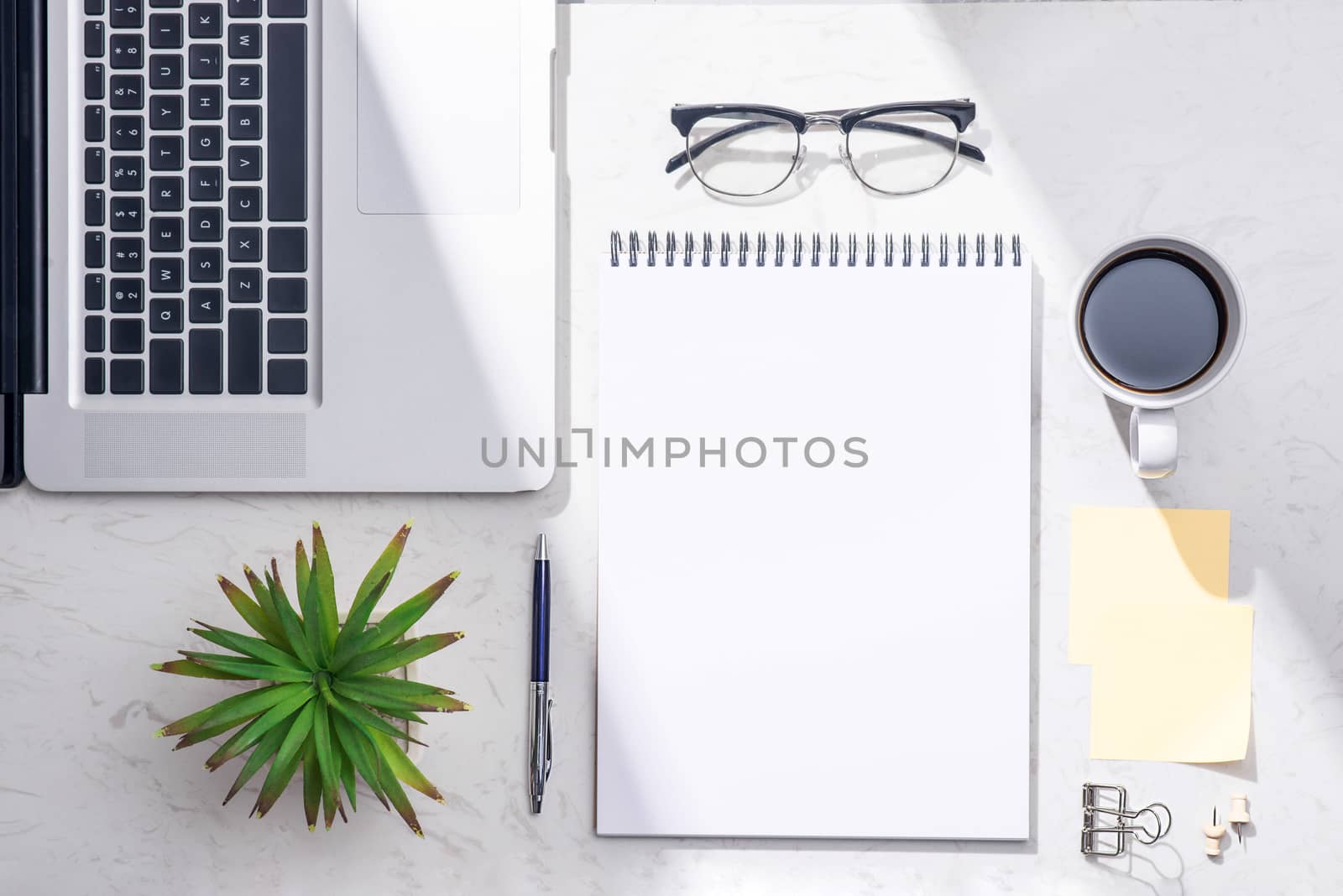 Flat lay, top view of open notebook and other supplies.