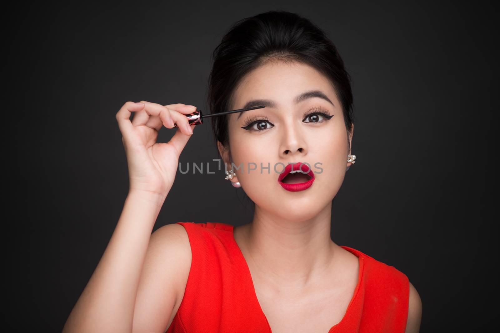 Make-up and cosmetics concept. Asian woman doing her makeup eyel by makidotvn