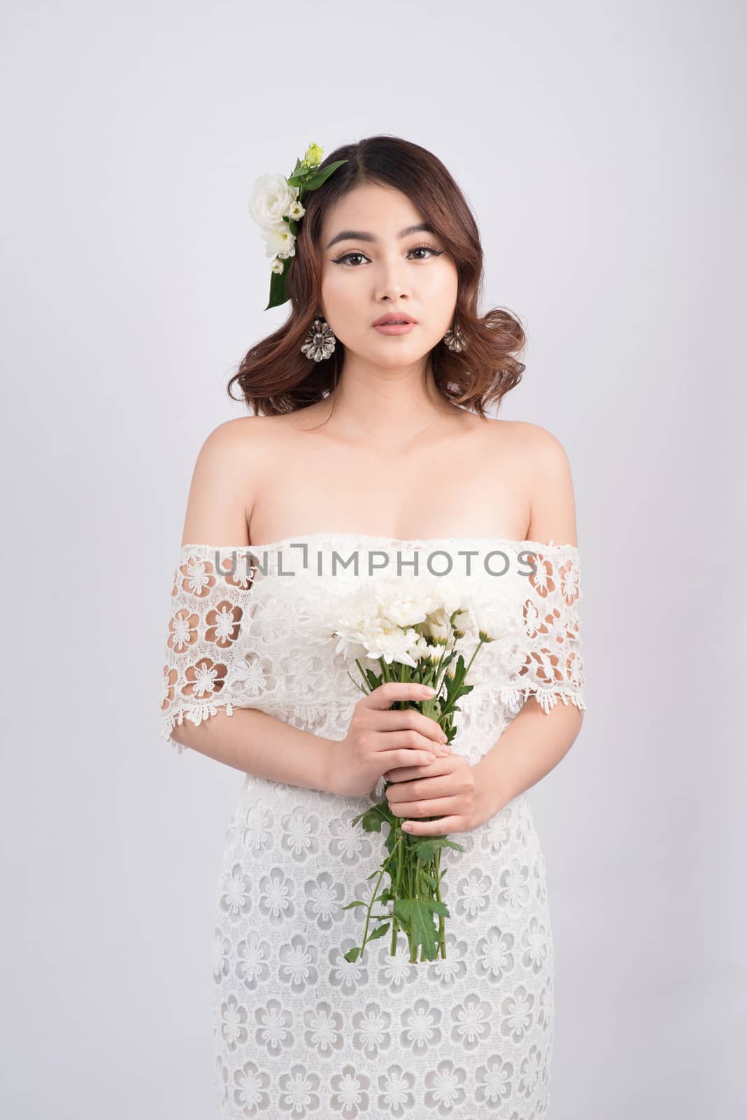 Beautiful asian woman bride on grey background. Closeup portrait by makidotvn