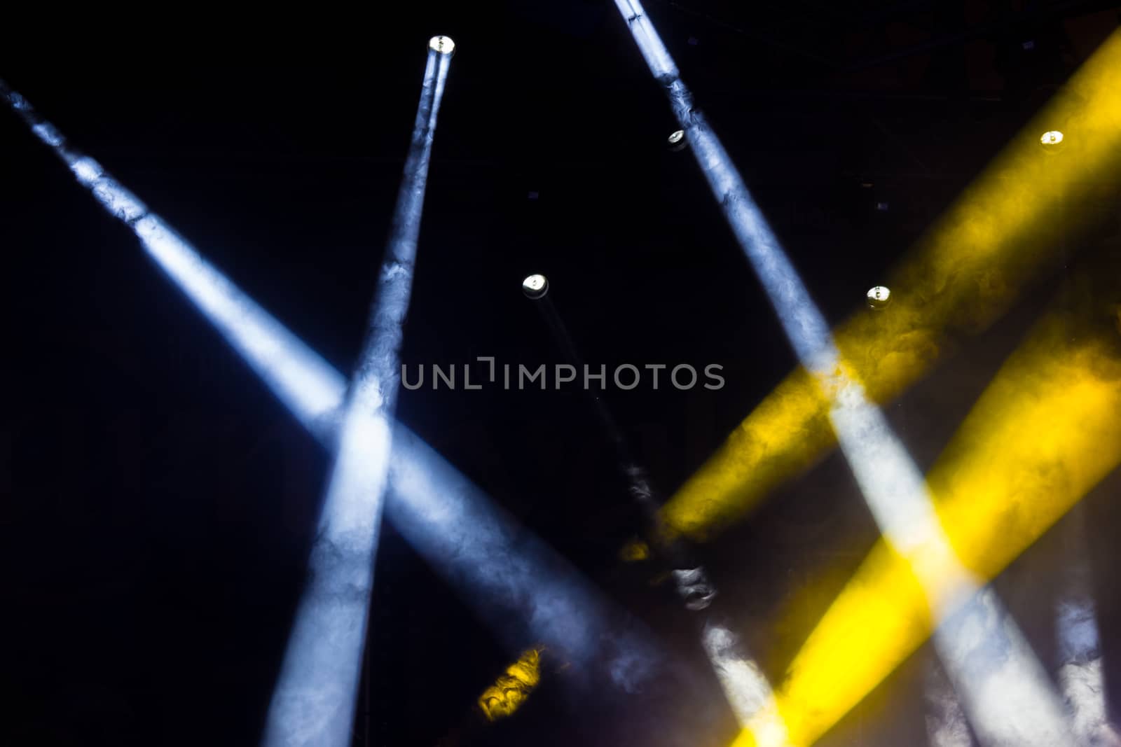 Colorful lights and smoke on a stage.