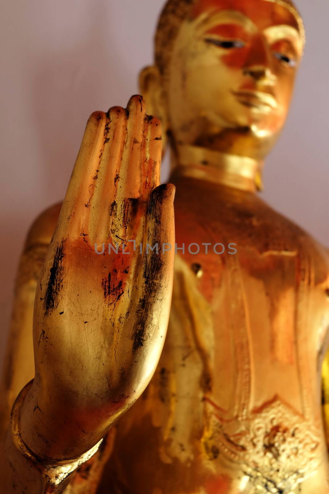 Hand of Ancient Golden Buddha Image. (Selective Focus) by mesamong