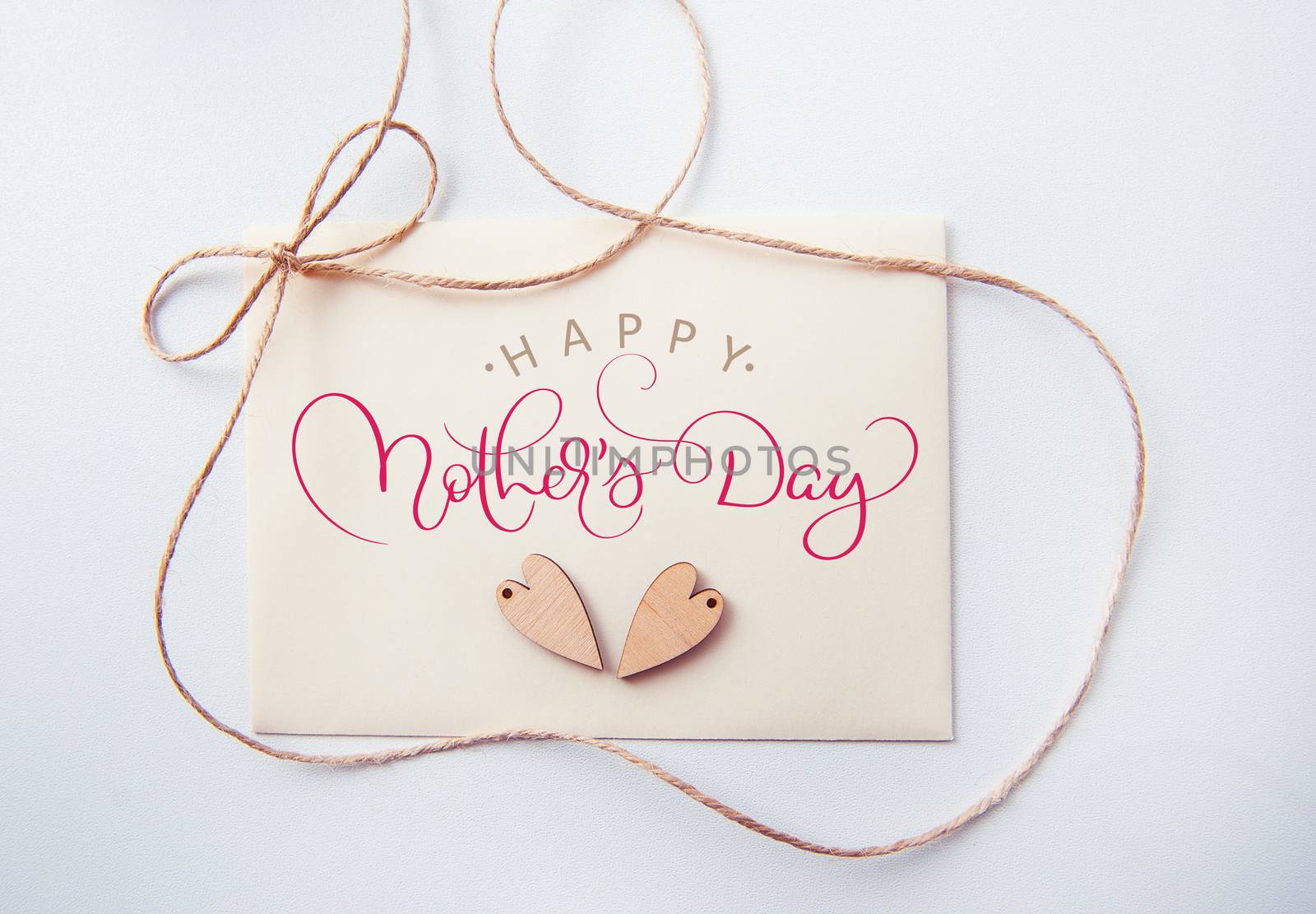 Holidays card with wooden heart and text Happy mothers day. Calligraphy lettering hand draw.