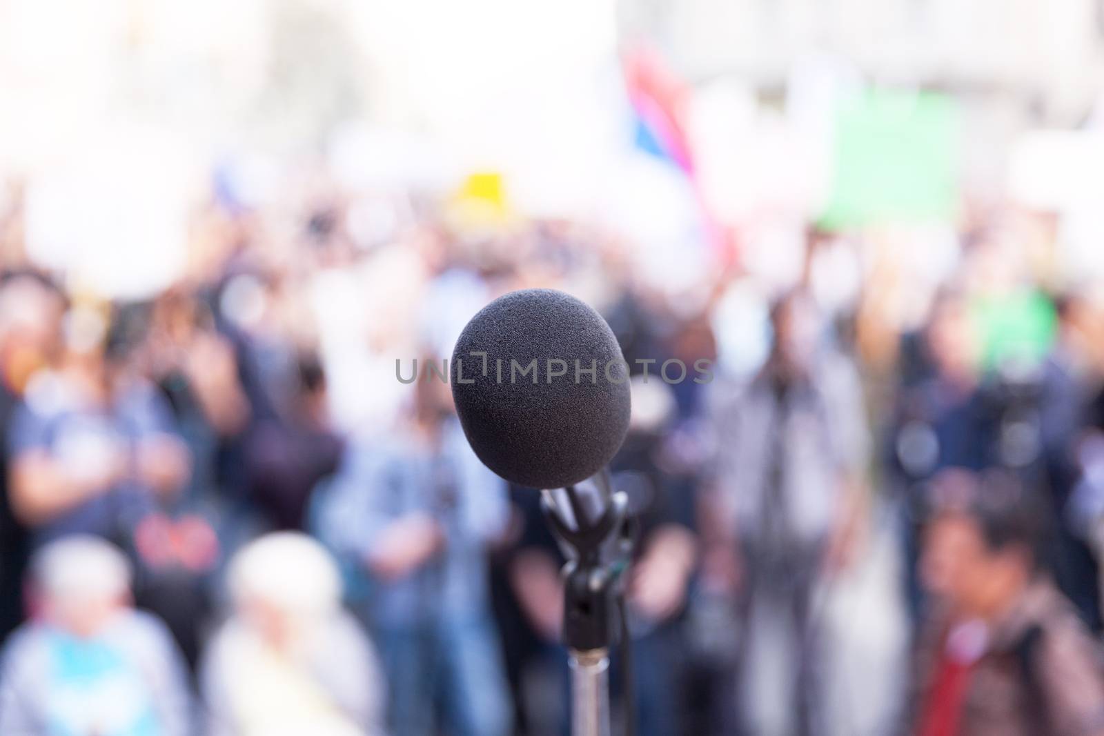 Microphone in focus, against blurred crowd by wellphoto