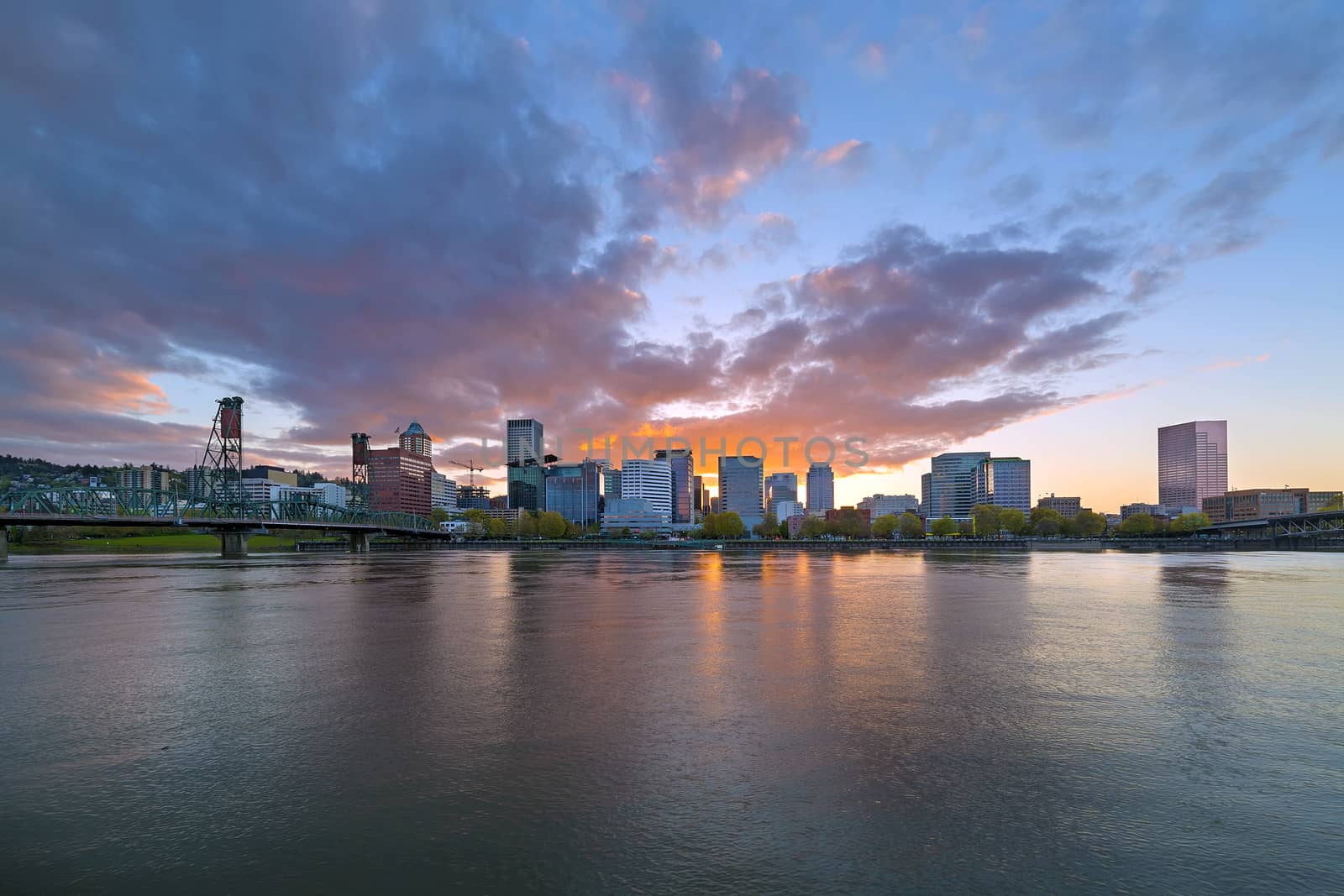 Sunset over sklyine of Portland Oregon by Hawthorne Bridge along Willamette River