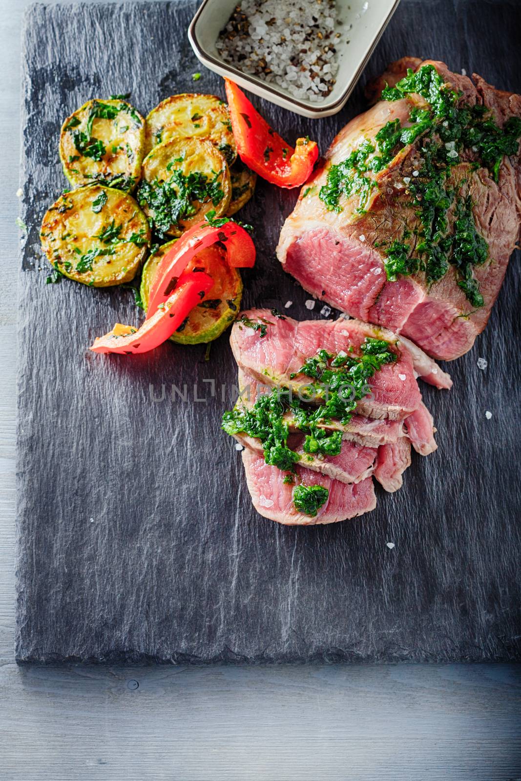 Roast Beef dinner with roasted zucchini, pepper and salsa verde
