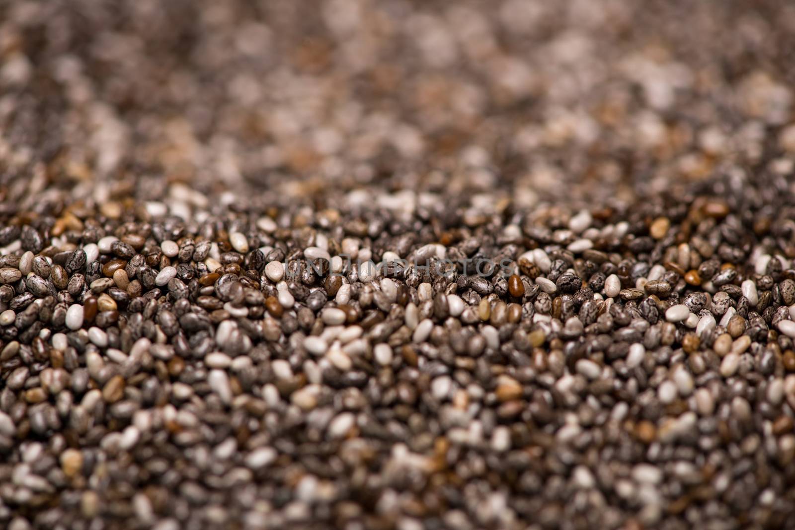 Close-up of raw, unprocessed, dried black chia seeds by makidotvn