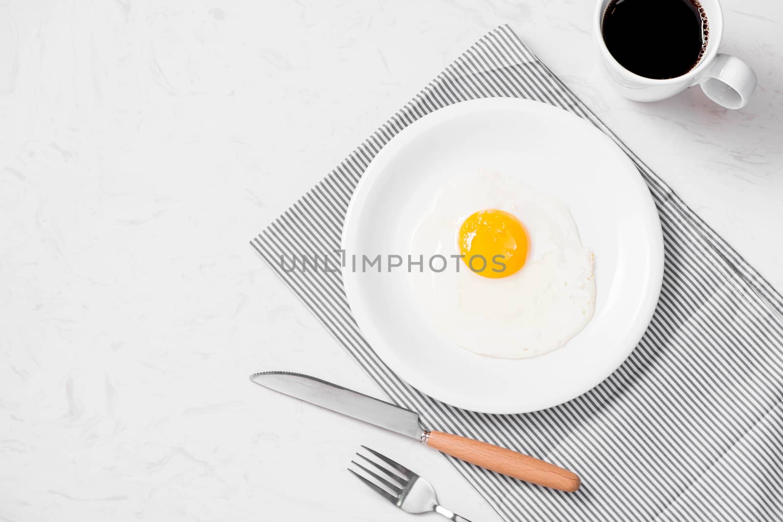 Top view of traditional healthy easy quick breakfast meal made of fried eggs served on a plate.