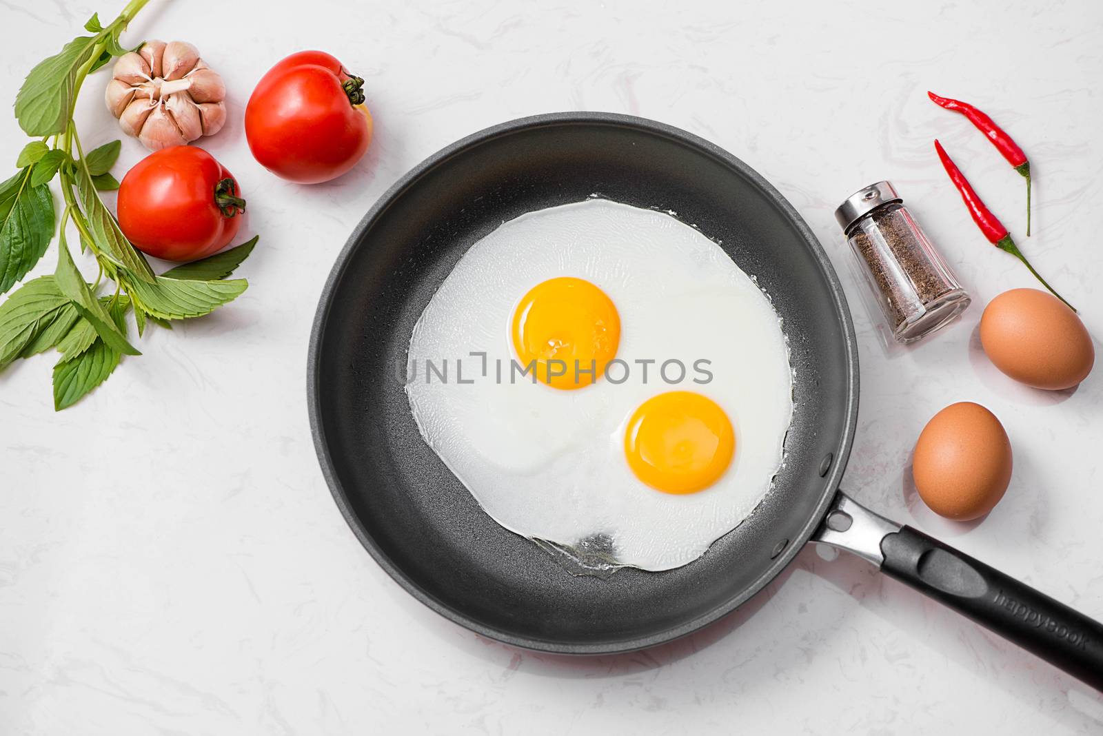 Fried eggs in a frying pan with cherry tomatoes and bread for br by makidotvn