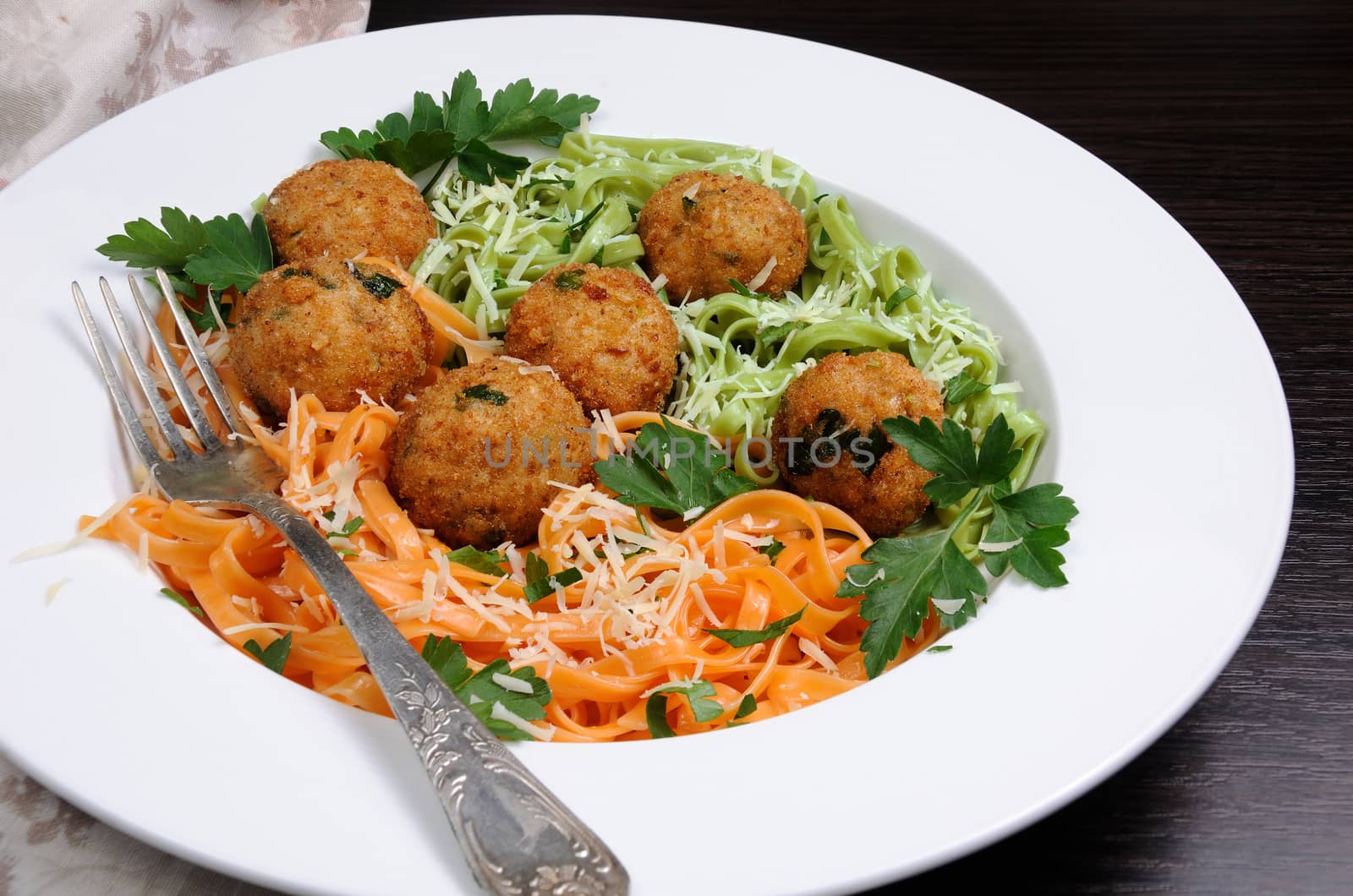 Spaghetti from carrots and spinach with chicken meatballs flavored cheese parmesan, herb