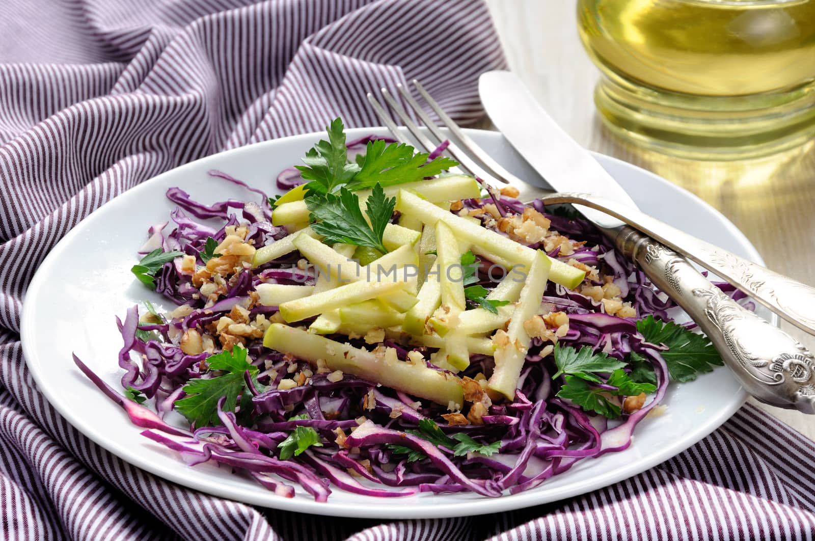 Salad red coleslaw with apple slices and crushed walnut