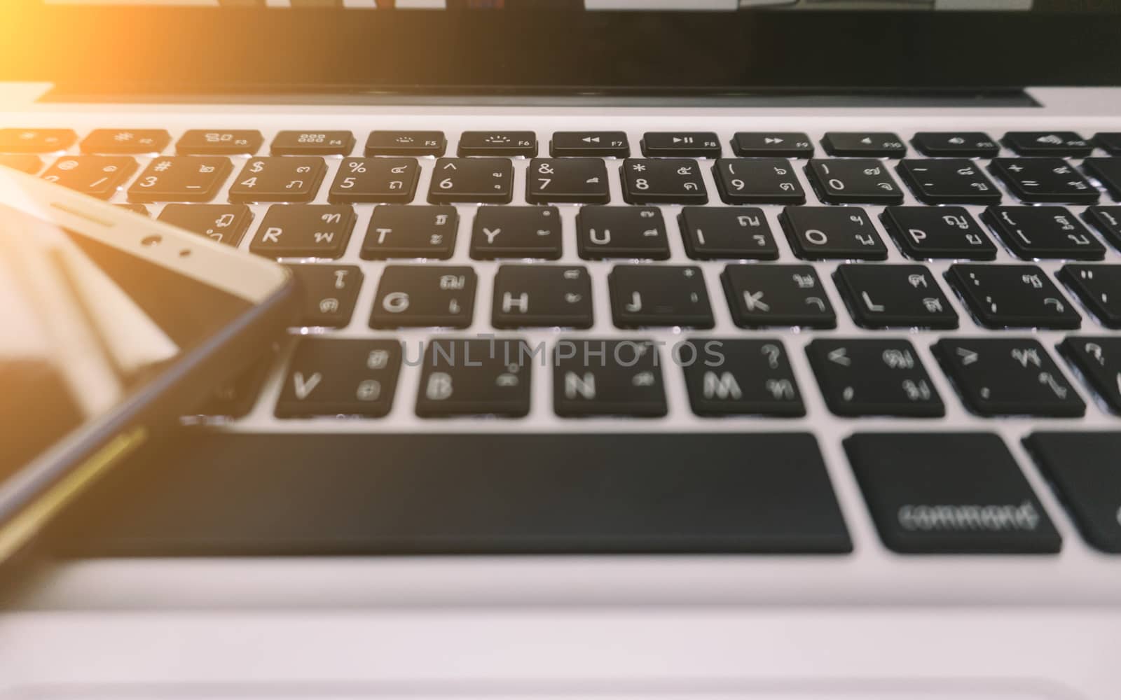 Laptop on the Desk with Mobile Phone .